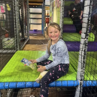girl happily playing in trampoline in the SEN support space center